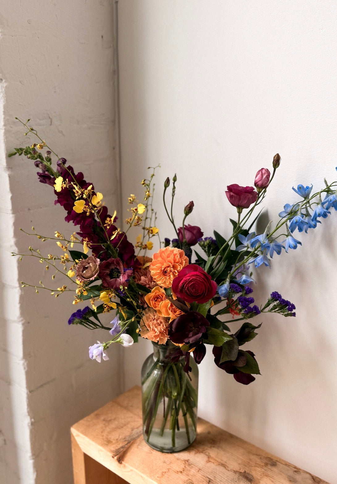 Midnight Blossom moody autumn flower arrangement in a clear glass vase